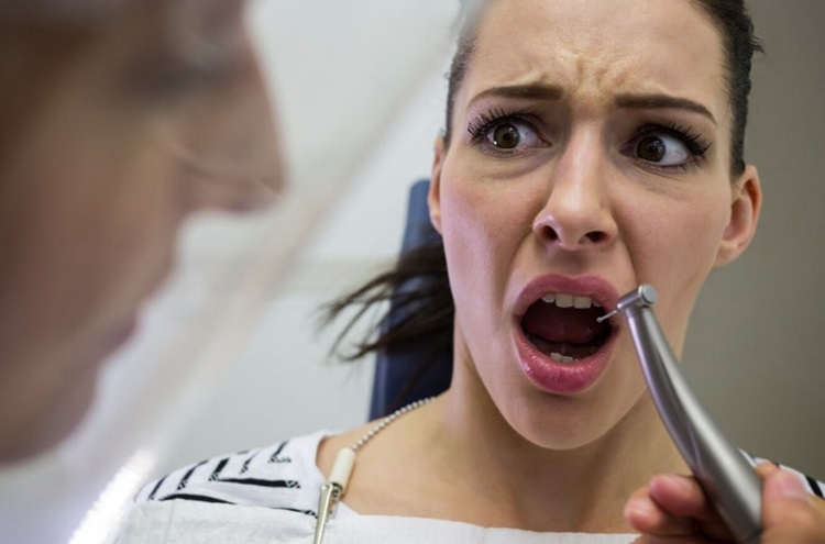 scared woman visiting dentist