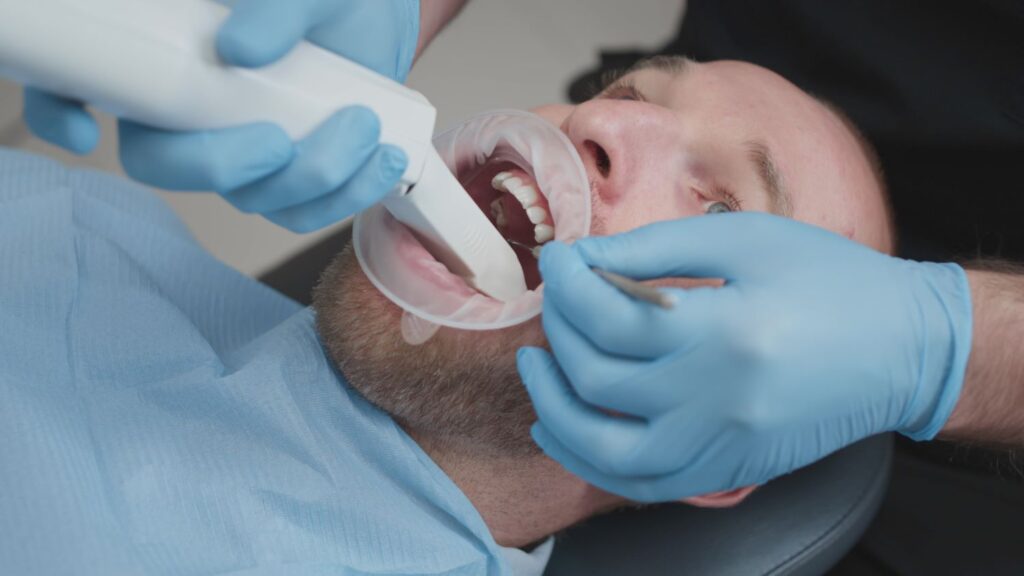 dentist taking impressions of prepared teeth for veneers