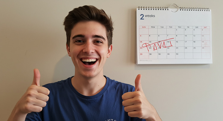 a happy person showing thumbs up because they have passed their healing time after tooth extraction and a calendar is showing 2 weeks have passed.