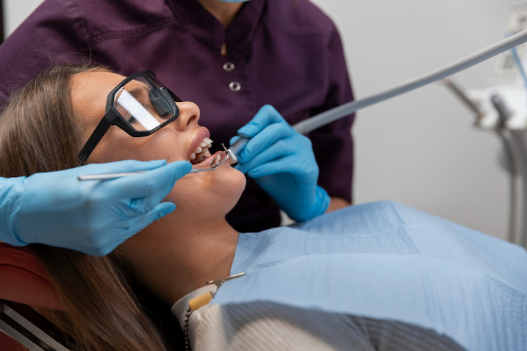 a patient receiving dental fillings in her front tooth.