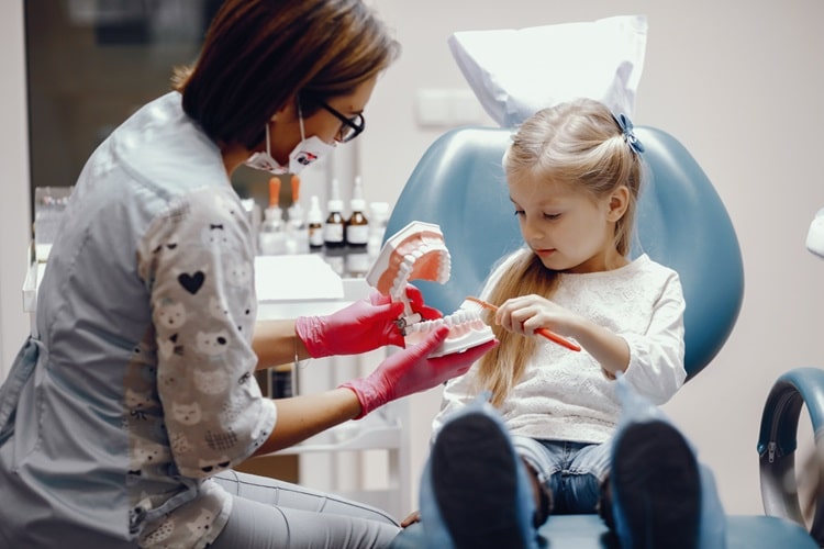 a dentist giving oral health tips to a child