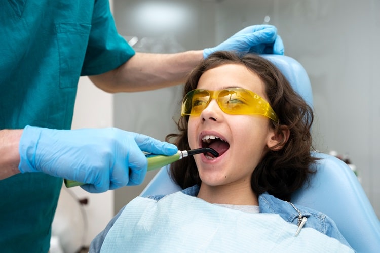 Professional Cleaning and Fluoride Treatment by dentist for a child