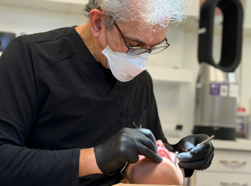 Dentist performing dental procedure on patient.