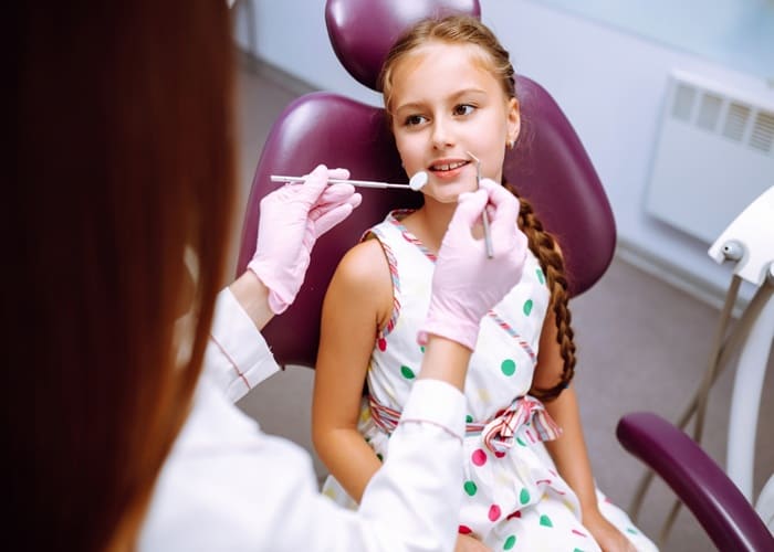 a dentist checking a child