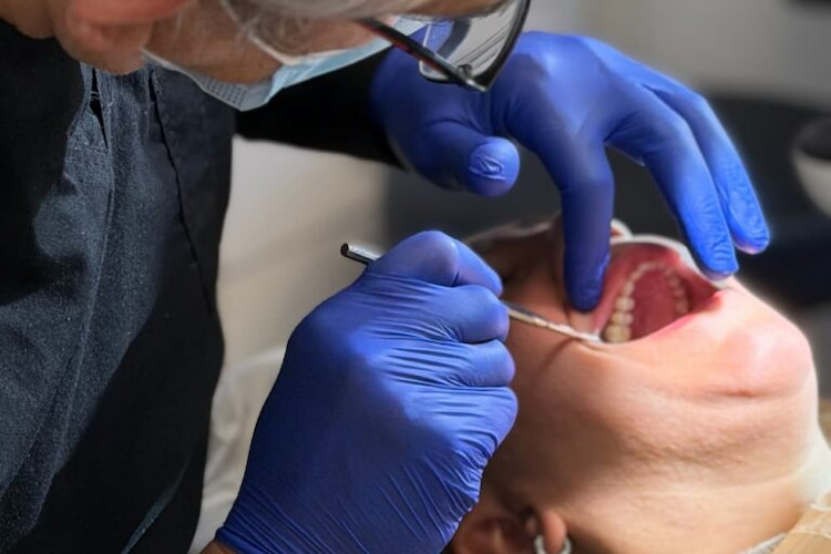 a photo of an Iranian dentist in North York doing oral cancer screening