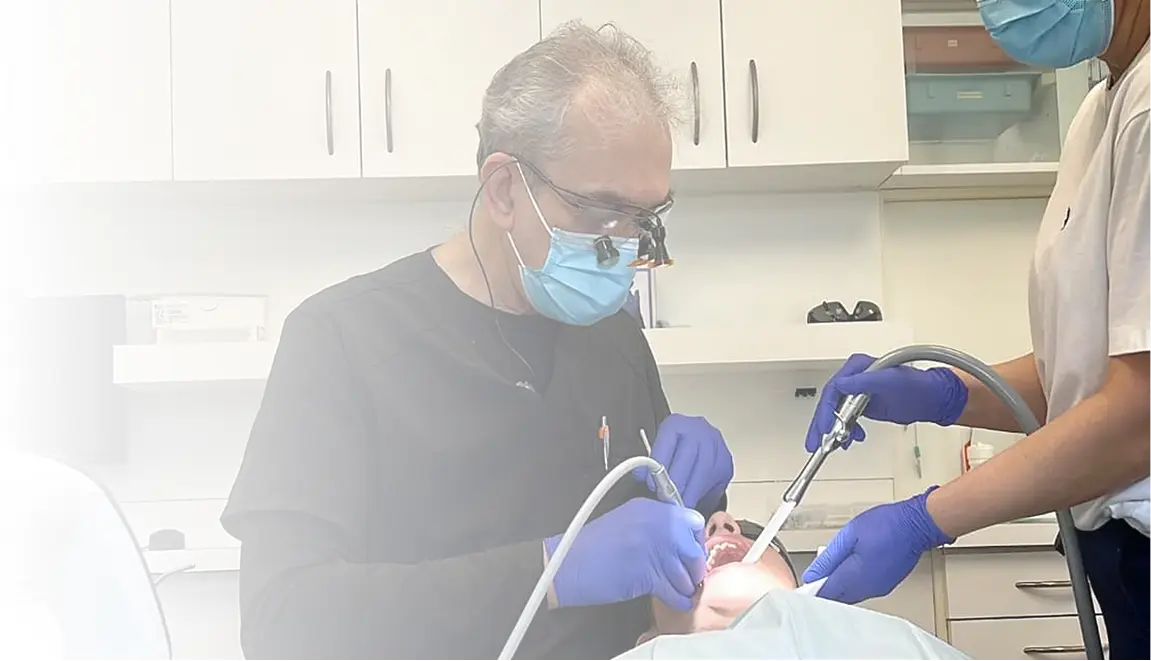 Dental professional and assistant examining a patient.