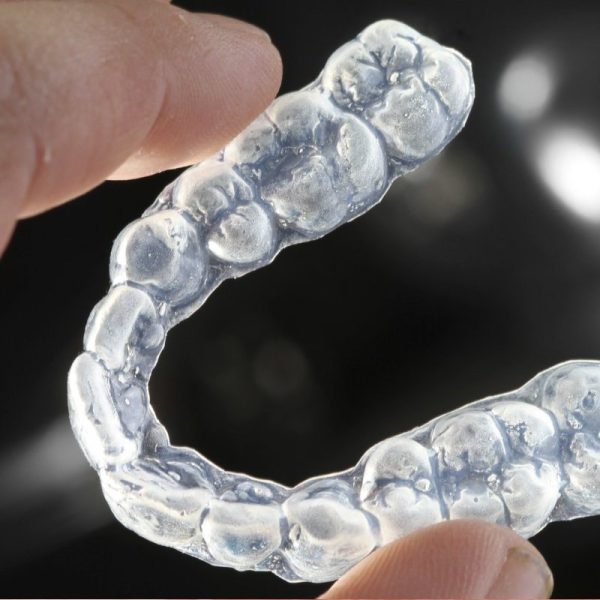 Clear retainer held in hand